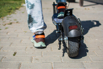 Electric Scooter, Electric Scooter Commuting.
Concept Object Photo Of Electric Scooter For Commuting. Close Up of Woman Commuting With Electric Scooter To Work.