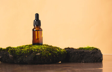 Bottle of cosmetic product on concrete stone with moss on beige background, eco and natural beauty...