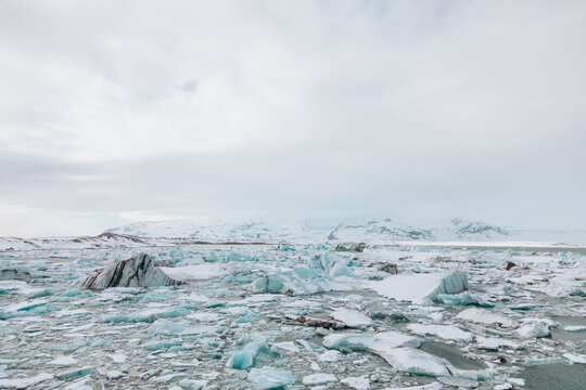 Ice chunks on water surface in arctic terrain