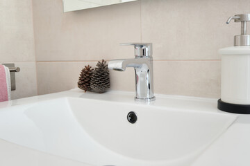 Bathroom countertop with bottle of hand gel and ornaments