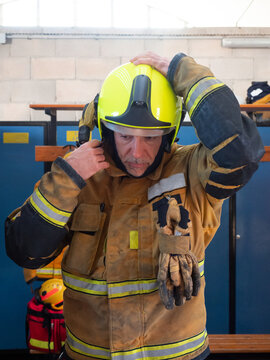 Fireman putting on his helmet in fire department