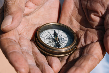Crop person with compass in desert