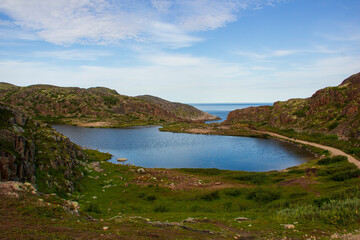 Landscapes of the Murmansk region. Waterfall on Small Battery Lake, Teriberka, Russia.