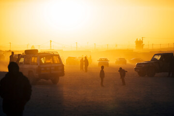 Cars and people in refugee camp