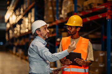 Warehouse staff meeting, worker with manger