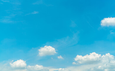 White fluffy cumulus clouds on blue sky with copy space for text. White puffy cloudscape. Beauty in nature. Close-up white cumulus clouds texture background. Sky on sunny day. Pure white clouds.