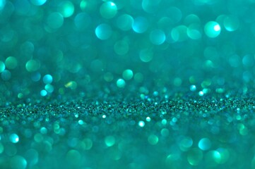 Abstract turquoise bokeh glitter on nature background