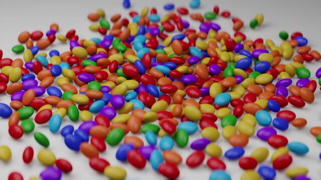 Bright and colorful candy beans or peanuts are falling down. Multicoloured tasty sugar sweets. Chocolate candies. Close up video. Red, green, violet, blue, yellow colors. Holiday mood. 3D Render in 4K