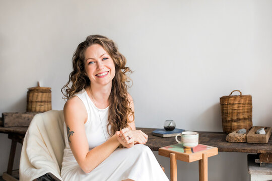 Attractive Smiling Woman Sitting In A Chair