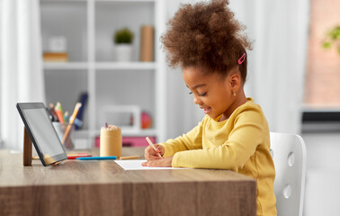 childhood, creativity and art concept - little african american girl with tablet pc computer...