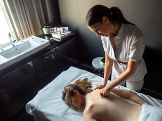 Woman having massage of body in the spa salon. Beauty treatment concept.