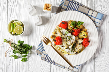 white fish fillets with veggies on a plate
