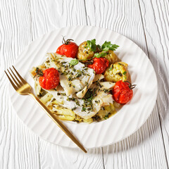 white fish fillets with veggies on a plate