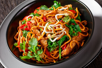 grilled soy meat strips with egg noodle in a bowl