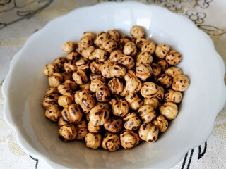 Chickpeas. Chickpeas on the plate. Plate of nuts on the table.