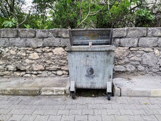 Garbage can. Big litter box. Garbage container on the street.