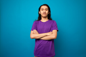 Long hair young man with smart thinking gesture, using t-shirt ,isolated background. 