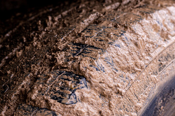 Car wheels in mud. Off road car dirty tire protector. Adventure travel concept background.