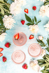 Glass Of White Wine, sweet fresh strawberries and Peony Flowers. Summer drink for party, wine shop or wine tasting concept