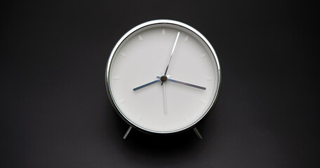 Silver Alarm clock isolated on black background, Showtime 08.17 am or pm.