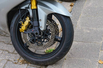 Close up of motorcycle front wheel.