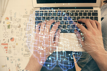 Double exposure of man's hands typing over computer keyboard and brain hologram drawing. Top view. Ai and data technology concept.