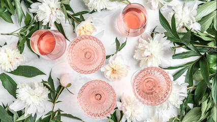 Many glasses of rose wine at wine tasting. Concept of rose wine and variety with Peony Flowers on...
