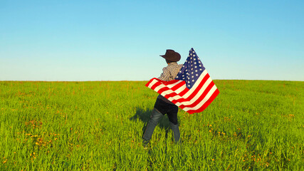 A man with the USA flag on natural landscape background.