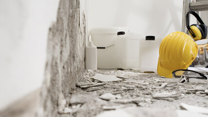 house renovation concept, wall in demolition with plaster rubble and protective construction work...