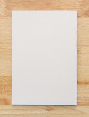 White paper texture on wood background.