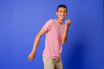 Handsome  young male with acne at face  laughing out loud , smiling broadly, dancing. Positive...