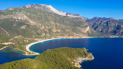 Fototapeta premium Ölüdeniz is a small neighbourhood and beach resort in the Fethiye district of Muğla Province, on the Turquoise Coast of southwestern Turkey, at the conjunction point of the Aegean and Mediterranean se