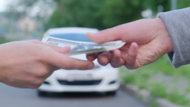 A man buys a car or takes it for rent, close-up