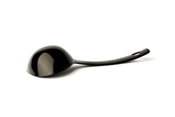 black plastic ladle from a multicooker isolated on a white background.