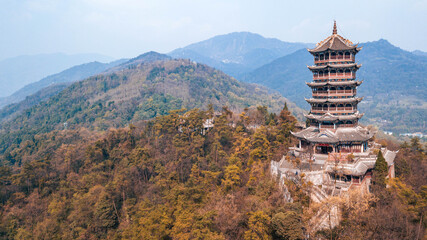 Aerial drone point of view of Dujiangyan, Chengdu, Sichuan, China. Mountain Qingcheng in the summer morning. Spin around up behind the woods mountain with pagoda tower on the hill top. Worship place