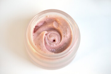 Cream in a jar on a white background