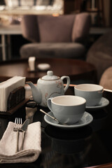 tea ceremony in a cafe. cups and teapot on the table mocap