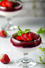 Traditional Italian dessert vanilla strawberry panna cotta in verina with fresh berries. Copy space.