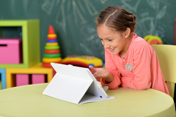 little girl using tablet