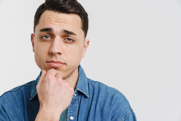 Young brunette white man posing and looking at camera