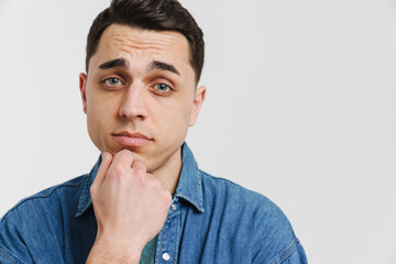 Young brunette white man posing and looking at camera