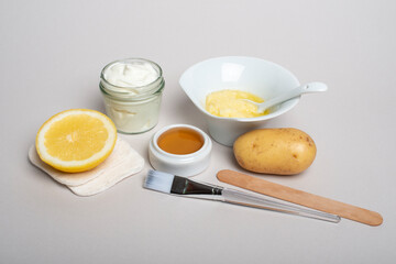 Ingredients for Potatoes facial mask: potatoes, honey, lemon, yogurt. Homemade skin care product.