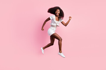 Fototapeta na wymiar Full body profile photo of carefree excited dark skin girl hurry fast look camera isolated on pink color background