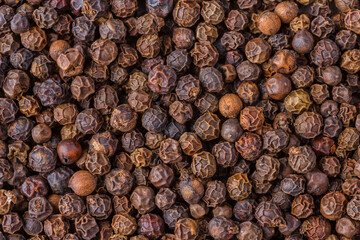 Large pile of allspice peas. Food background.Background made of middle eastern traditional spice . Top view.Textures of colorful spices and condiments.