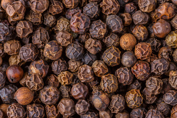 Large pile of allspice peas. Food background.Background made of middle eastern traditional spice . Top view.Textures of colorful spices and condiments.
