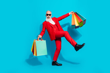 Full length body size photo aged man keeping bags shopping mall happy careless isolated vivid blue...