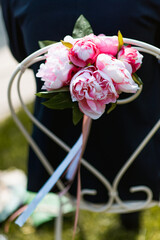 Flowers decorations tied on a chair during a bridal ceremony