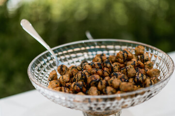 meatballs with balsamic vinegar on a glass bowl. Buffet and catering during an elegant party.