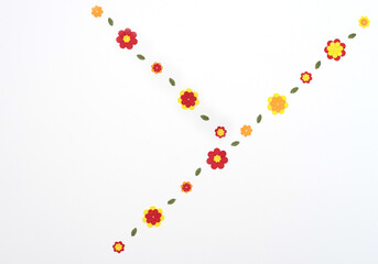 Bright red, yellow, orange paper flowers on white background. Spring, summer concept. Flat lay style with copy space