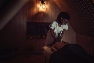 massage of a beautiful woman, body care.